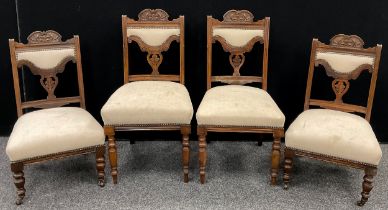 A late Victorian part salon suite - carved walnut top rail and splat, sprung seats, turned fore-
