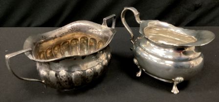 A George V silver cream jug, Henry Wigfull, Sheffield 1919; a gadrooned twin handle sugar bowl,