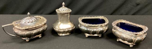 An Edwardian silver three piece condiment set, pair of open salts and pepper, Thomas Levesley,