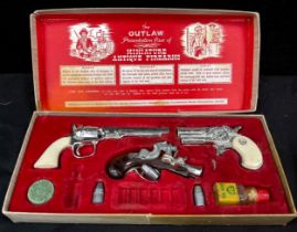 BCM (Derby), Cap Guns - A vintage boxed 'Outlaw Presentation Case of Miniature Antique Firearms' toy