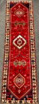 A South-west Persian Qashgai runner carpet, hand-knotted in rich colours, with five medallions,