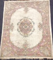 A large Chinese woven wool rug,in tones of pink, cream and green, 284cm x 225cm; another 350cm x 251