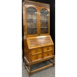 An early 20th century oak bureau bookcase, 207cm high x 85.5cm wide x 44cm .