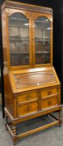 An early 20th century oak bureau bookcase, 207cm high x 85.5cm wide x 44cm .