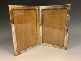 A silver diptych double photograph frame, marked Sterling