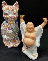 A 20th century porcelain figure, Happy Buddha, holding two pearls aloft, faint accession number to