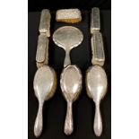 A silver four piece dressing table brush set, marks worn, possibly Birmingham 1919; other brushes,