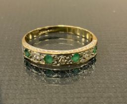 A diamond and emerald half eternity ring, alternate set with four emeralds and three three round