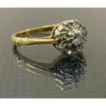 A diaamond cluster ring, set with nine round brilliant cut diamonds , yellow metal shank, stamped