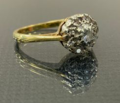 A diaamond cluster ring, set with nine round brilliant cut diamonds , yellow metal shank, stamped