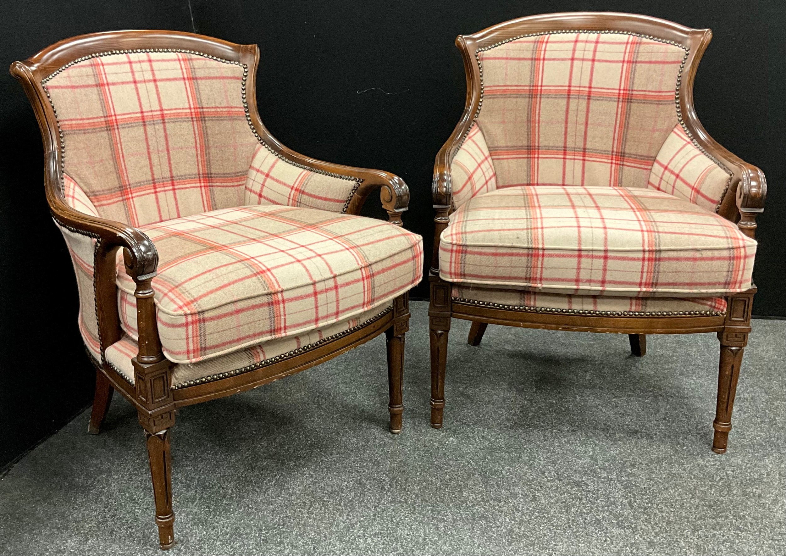 A pair of tartan upholstered armchairs, serpentine shaped backs, with scroll arms, upholstered backs