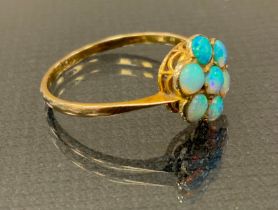 An opal cluster ring, seven blue green cabochon opals, 9ct gold shank, size O, 1.2g gross