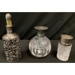 A Victorian silver mounted scent bottle, embossed floral body, marks worn; another hobnail cut
