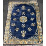 A Chinese silk and wool mix rug, central floral medallion within blue ground, stepped floral borders