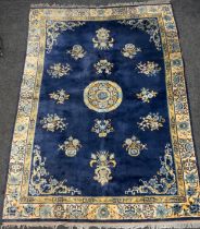 A Chinese silk and wool mix rug, central floral medallion within blue ground, stepped floral borders