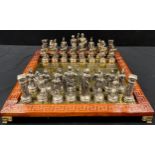 A cast metal Greco Roman chess set, possibly Manopoulos & Spartacus, king 10.2cm high, with brass