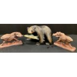 A pair of carved figures, warthogs, 14.5cm x 24.5cm, a larger Black Forest style Bear and Fish (3)