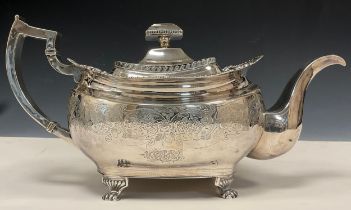 A George III Irish silver teapot, cast and chased ovoid body, shaped rim, floral collar, paw feet,