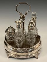 A George IV silver five bottle cruet stand, boat shaped stand, central carrying handle, with five