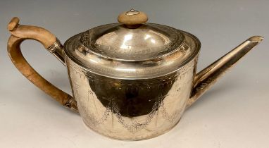 A George III silver teapot, oval body with floral swags and leafy motifs, wooden handle and