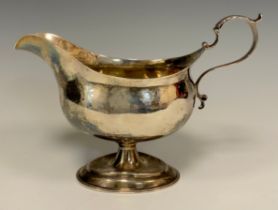 A George III silver pedestal sauceboat, acanthus-capped handle, domed oval foot, 19cm long,