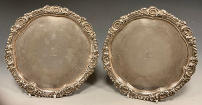 A pair of George III silver waiters, cast shell and leaf scroll floral border, lobbed circular