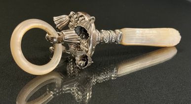 A late Victorian mother of pearl and silver babies tether with embossed floral body, four bells,