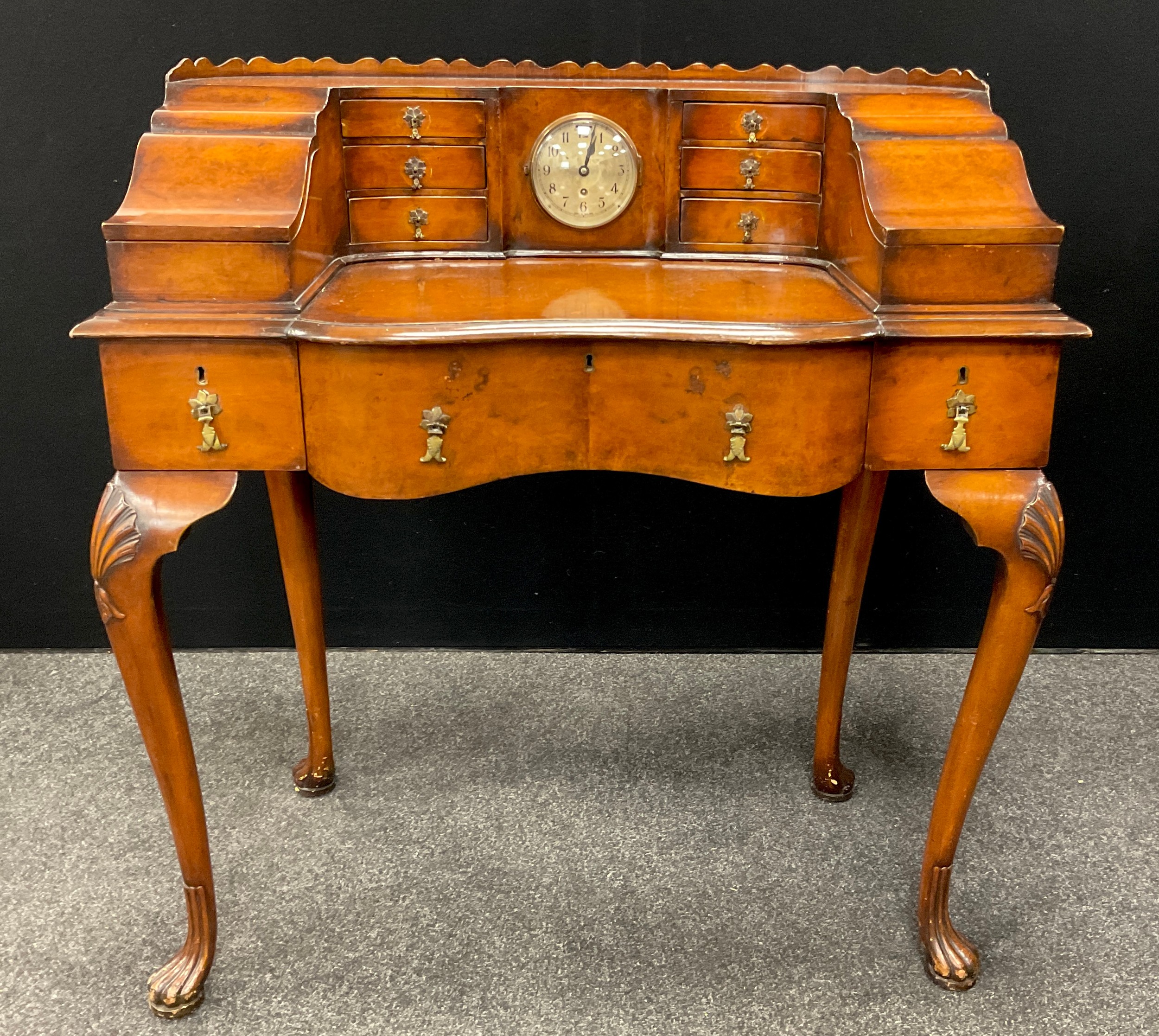 A Carlton House style walnut writing desk, the galleried super ...