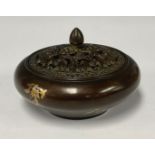 A reproduction Chinese bronze censer and cover, decorated with gold splash, character marks to base