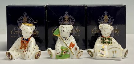 A Royal Crown Derby miniature shopper bear, Graduate, 7cm high; two others, Gone Fishing, 6cm high