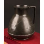 A German Jugenstil Kayserzinn pewter jug, moulded with a shoal of fish, lily pad borders, angular