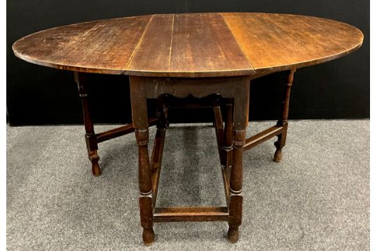 A 19th century oak drop leaf table, oval top, turned supports, peg joints, 151.5cm x 122cm open ( - Image 1 of 2