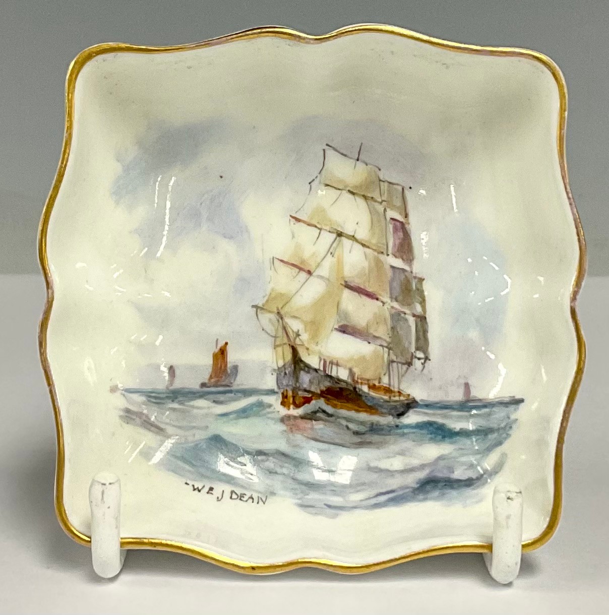 A Royal Crown Derby shaped square trinket dish, painted by WEJ Dean, signed, with ships at sea, 7.