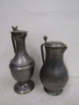 2 large, heavy pewter jugs with fleur d' lys emblem tallest 37cm