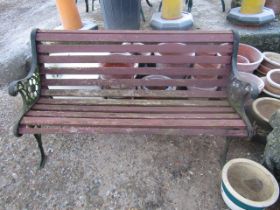 A wooden bench with cast iron ends