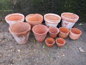 11 Terracotta garden pots. Largest H24cm approx