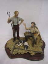 Border Fine Arts style figurine of two farmers and sheepdog sitting in raked hay on a wood