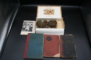 A cigar box with scales and part set of weights. Together with 3 hand written books, one on costs,