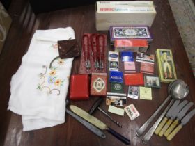 A collectros lot inc cigarette cases, matches, vintage tablecloth, flatware, toffee hammer etc etc