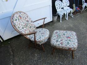 Upholstered Ercol stick back armchair and footstool with hunting themed pattern fabric