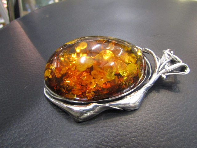 A large re-constituted Amber and Polish silver pendant 10cm long stamped 925