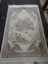 A cream ground rug with Oriental peacock design 200x122cm