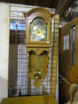 A German Interlock wall hung  long cased clock with oak case, brass weights and key, plus manual