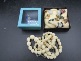 7 pairs clip on earrings, a ring and carved bone beaded necklace with spare beads