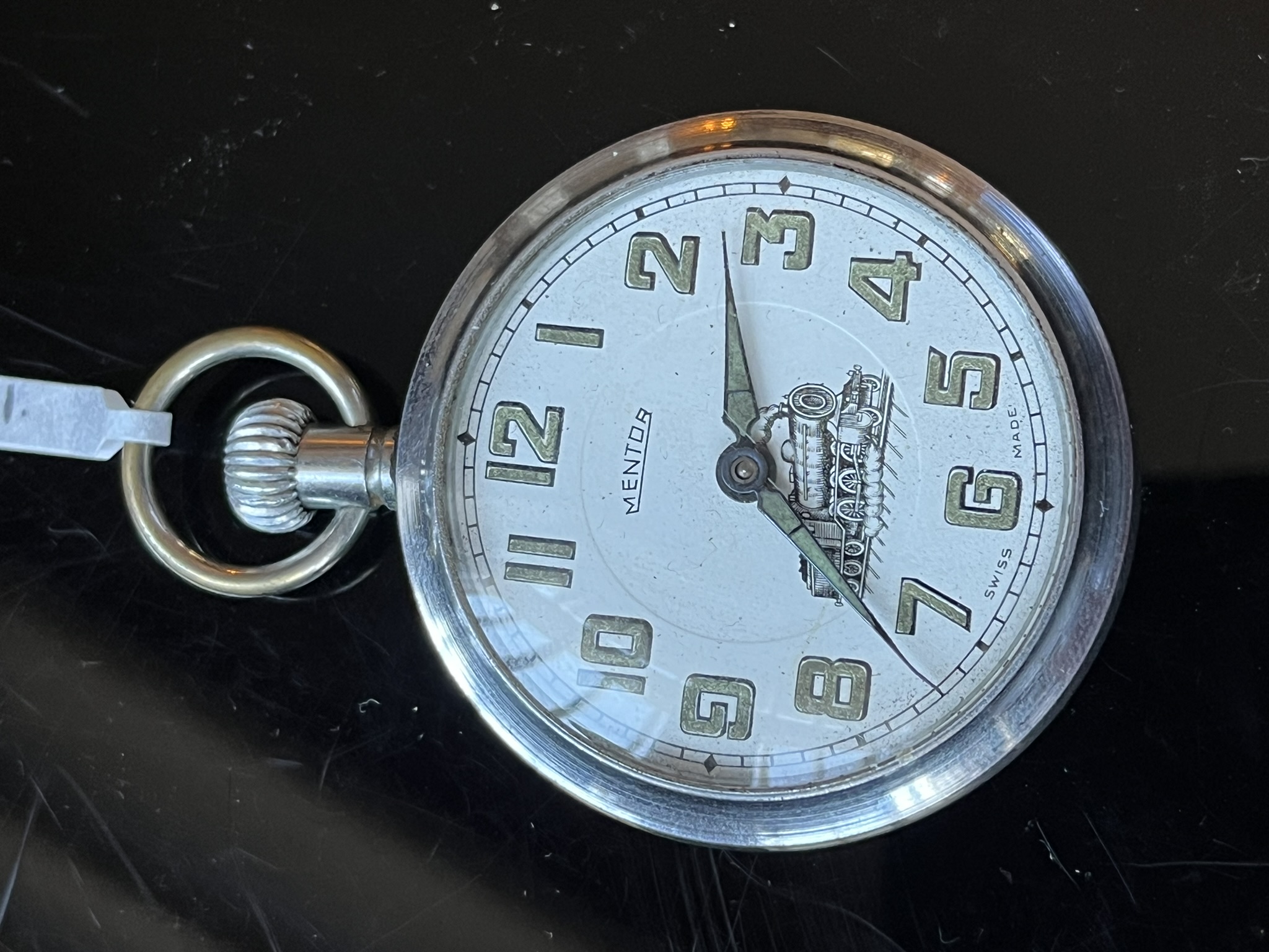 An early-to-mid 20th Century Mentor stye pocket watch with white enamel face steam engine train on