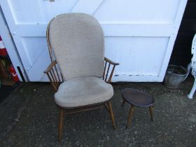 Upholstered Ercol stick back armchair and stool
