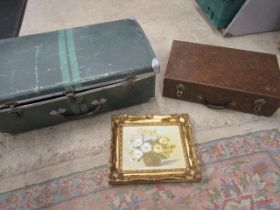 A vintage metal trunk and picnic basket/case along with a small still life oil painting.