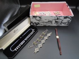 A box of costume jewellery - to include clip-on earings, a vintage Inventic ladies watch with