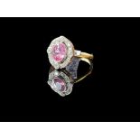A pink sapphire and diamond ring, set with an oval pink sapphire weighing 0.60 carats, within a