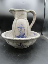 A jug and bowl set depicting a ship with a crackle glaze and stamp to bottom studio pottery?